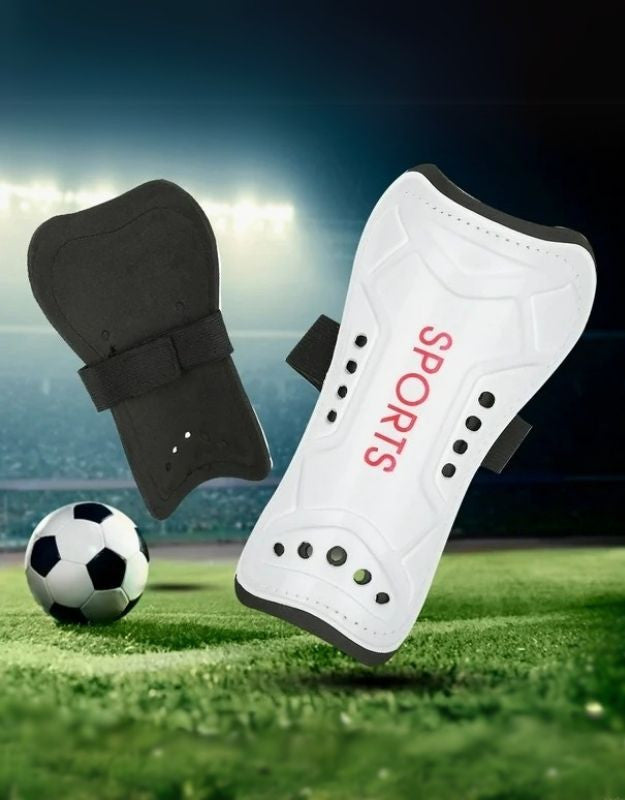 White soccer shin guards with straps for leg protection during football games.